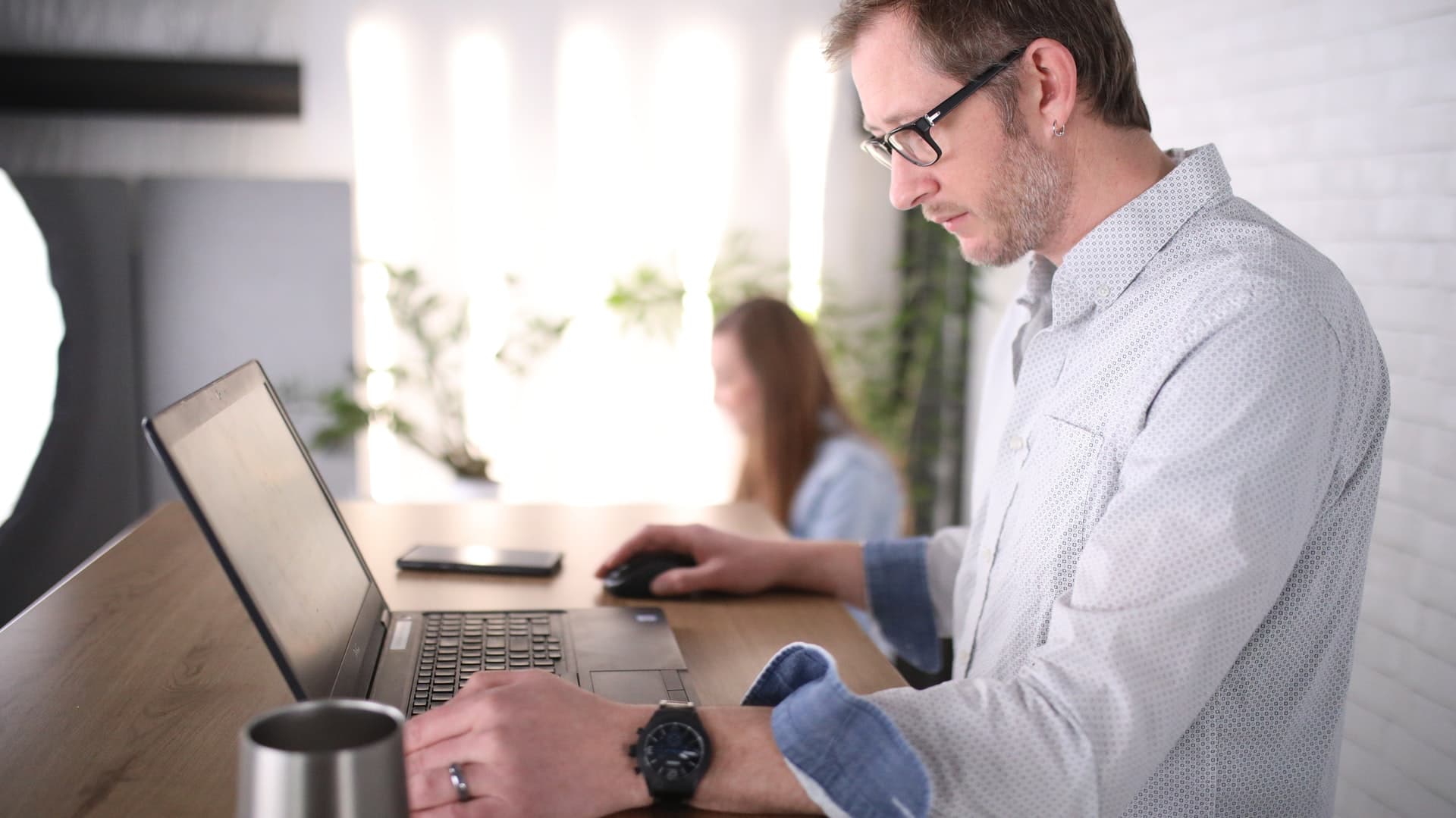 Guy standing at desk